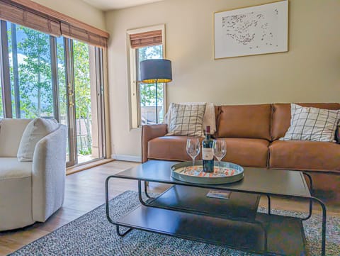 [1st Flr Living Room] The comfy couch opens up to a queen-sized bed