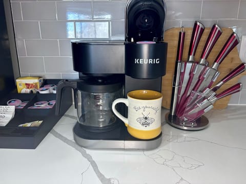 Keurig coffee machine (pod + coffee pot), charcuterie + cutting board