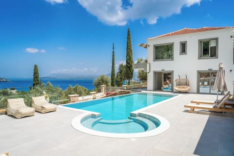 Outdoor swimming pool area with jacuzzi and barbeque offering amazing sea views
