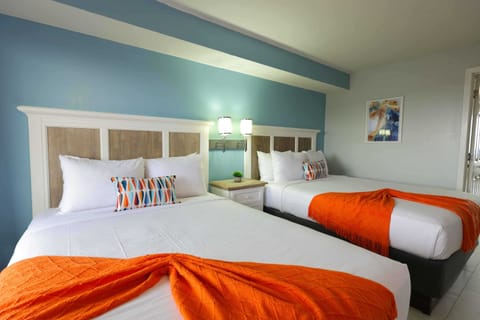 Bright, bold, and beachy! Drift off in comfort with two dreamy queen beds, playful pops of color, and just the right vibe for your coastal getaway. Perfect for friends, family, or anyone chasing sunshine and sleep.