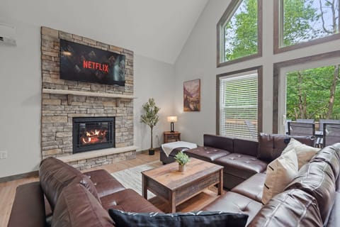 Living Room with Fireplace & Netflix
A cozy central hangout spot with a stone fireplace, large sectional, and a mounted TV for movie nights or lazy afternoons.