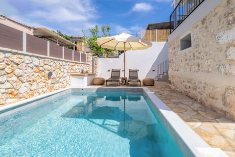 Outdoor area with swimming pool, sun beds, barbeque and parking space 