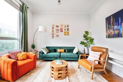 Bright, stylish living room with cozy seating and vibrant decor.