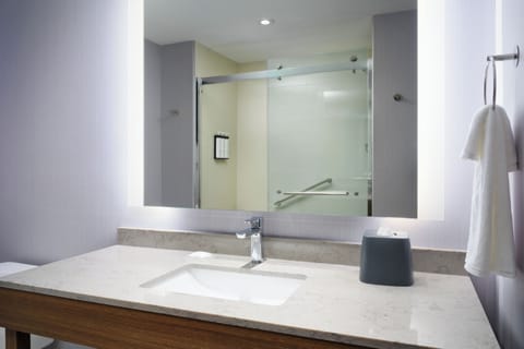 Refresh each morning at a bright vanity and glass shower.