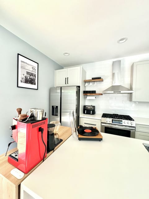 Living room seamlessly flows into a kitchen, equipped with high-end appliances.