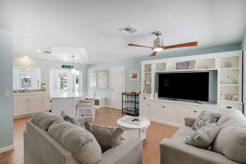 Large open concept living room with ample seating and flat screen TV