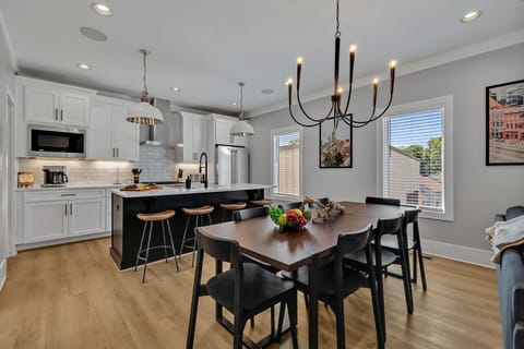 Unit 1 - 2nd Floor: Formal dining area featuring a large table set to accommodate 8 guests.