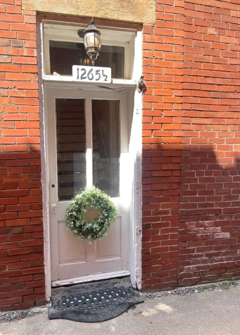 Located in the ally on the North side of the located on the north side building