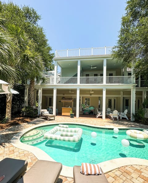 Pool and backyard, multiple porches, patio, tiki bar, sun loungers, pool floats