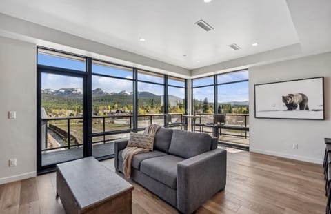 Expansive windows frame stunning mountain views—perfect for relaxation and adventure!