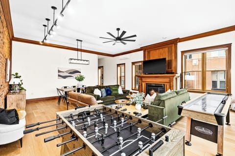 Open concept living room with game tables to keep your whole group entertained