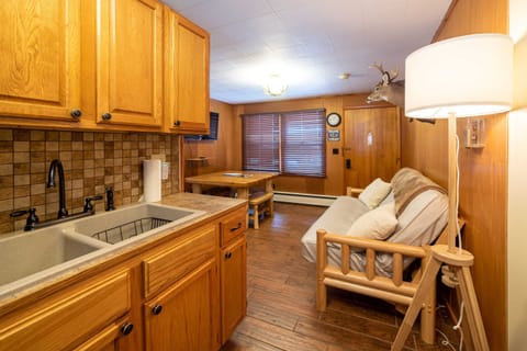 Kitchen sink with beautiful backsplash, looking out into the living area.