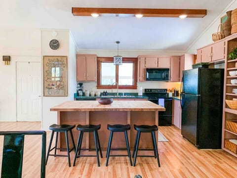 Enjoy a meal in the fully stocked kitchen with seating for 4 at the island.