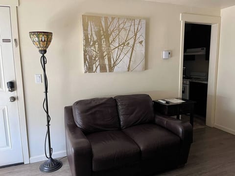 Comfortable leather loveseat with side table a lamp