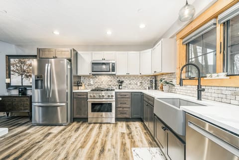 Beautifully designed, the kitchen has high-end appliances and a farmstyle sink.