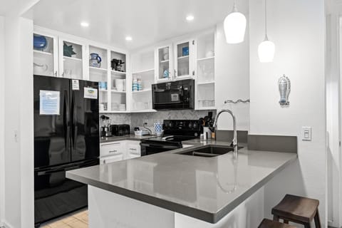 Beautiful remodeled kitchen with open storage and modern appliances