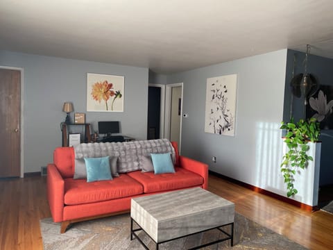 Inviting living area w/ electric fireplace, 65" TV, record player, desk, & AC