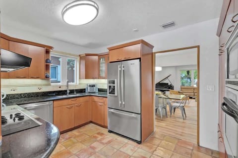 “Stay in this bright Airbnb rental with modern kitchen, cozy living area, and piano charm—perfect vacation rental for family meals, relaxation, and unforgettable getaways.”