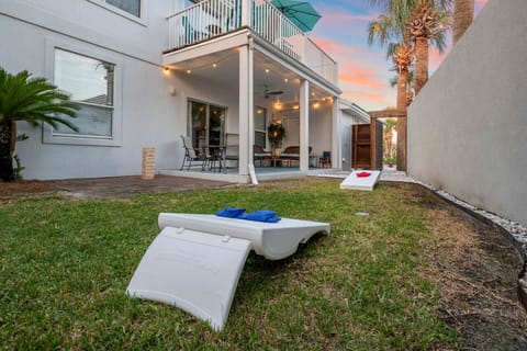 Enjoy a game of cornhole at Seahorse Shores, beautifully illuminated by Edison lights.
