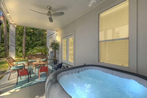 A relaxing back patio with a hot tub, perfect for unwinding and enjoying the outdoors in comfort!
