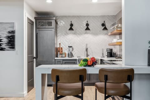 Fully equipped kitchen boasting stainless steel appliances and stocked with all culinary essentials.