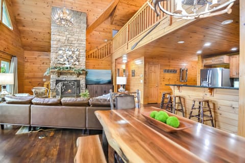 The main living area with a tall, stone fireplace and a large open space.