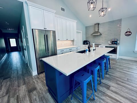 Spacious, modern kitchen with island seating and lake views.