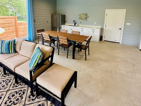 Large screened living / dining room with TV, refrigerator and full bathroom.