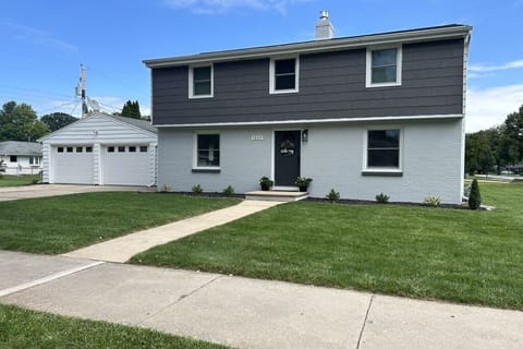 Front of home is well lit w/detached garage & parking for 4 cars in the driveway