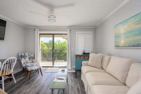 Open-concept living space seamlessly transitions into a modern, fully-equipped kitchen. 