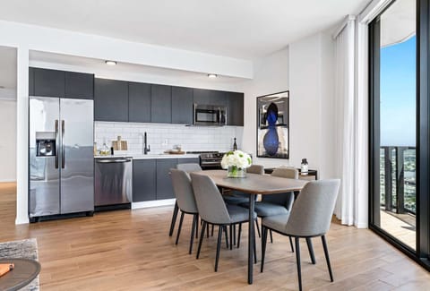 Gather for meals in a sunlit kitchen beside the balcony.