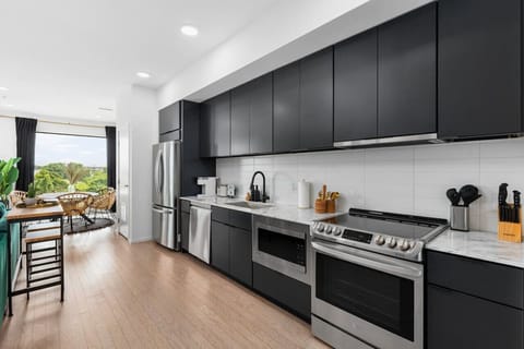 Fully equipped kitchen for all of your cooking needs! Keurig coffee machine + K-cups provided plus seating for 2 at the high-top table behind the couch.