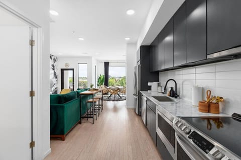 Fully equipped kitchen for all of your cooking needs! Keurig coffee machine + K-cups provided plus seating for 2 at the high-top table behind the couch.