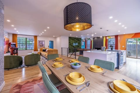 Vibrant open-concept dining, kitchen & lounge with fun design touches