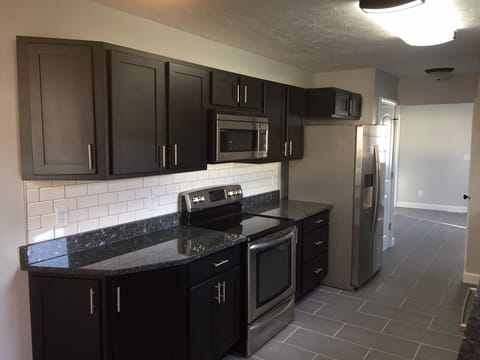 Blue Pearl Granite Countertops with Black Legacy Cabinetry