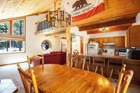 Dining area features seating for four in the dining room and 3 at the bar top. 