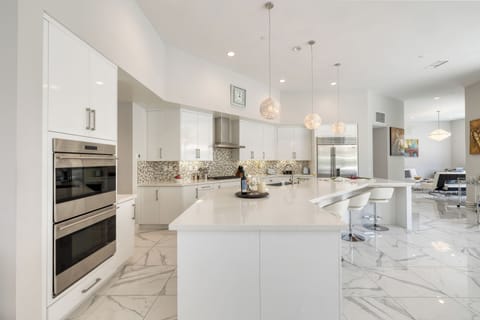 Bright, fully equipped kitchen with ample prep space.