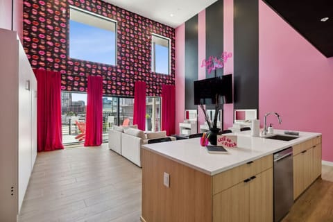 Bright, glam open-concept space with an oversized island, bold décor, and huge windows for natural light—perfect for pregame snacks, selfies, and lounging before a night out in Nashville!