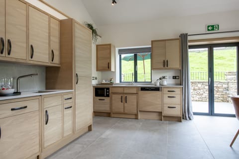 Ground floor: Kitchen with bi-fold doors leading out onto the patio