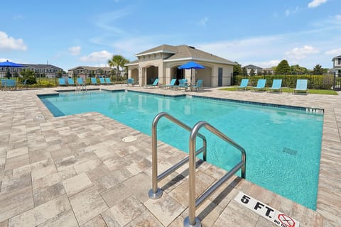 Enjoy the Luxury Community Pool with new paver deck and crystal-clear water.