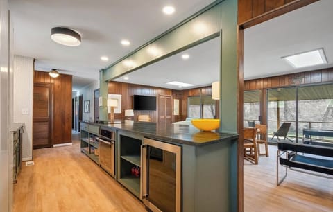 Open kitchen with island seating for four. Keurig, microwave, toaster oven, bev.