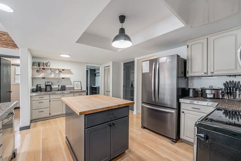 - Whip up meals in a stylish kitchen with a sleek island and stainless steel appliances
- Keep everything organized with open shelving and plenty of cabinet space
- Prep, cook, and dine with ease on gleaming wood floors and spacious countertops
