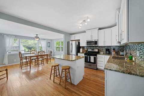 Embracing the timeless elegance of white cabinets and hardwood floors in this dreamy kitchen. 🌟🤍 #ClassicCharm #KitchenVibes #InteriorDesign