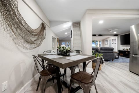 Modern dining table set for four, designed for convenience and comfort in a contemporary setting.