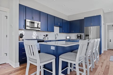 With seating for 5, the kitchen's center island is a popular gathering spot.