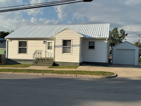 View of front entrance and driveway to the small garage.
