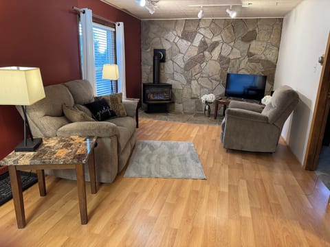 Living room with a gas fireplace and a smart TV.