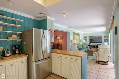 Full Kitchen and Breakfast Bar with view into Living Room