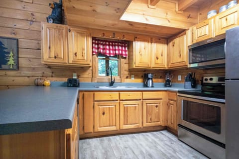 Kitchen: Whip up meals in this charming space with wood accents and inviting natural light!