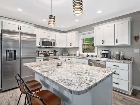 Kitchen is stocked with all of the essentials. Kitchen island provides seating for 2.